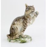 Meissen figure of a seated cat with a rat in it's mouth, on naturalistic base, blue crossed swords