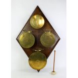 Set of four early 20th century brass gongs made from the base of artillery shell cases,