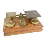 Late Victorian oak and brass parcel scales with brass weights, w43 x d25 x h14cms