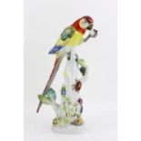 Modern Meissen figure of a parrot holding a stone, on naturalistic base, blue crossed swords,