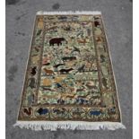 Persian ivory ground rug decorated with hunting scenes and animals, 228 x 134cm,