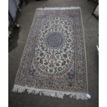 Nain rug, with blue medallion and all over foliate design on an ivory ground within multiple