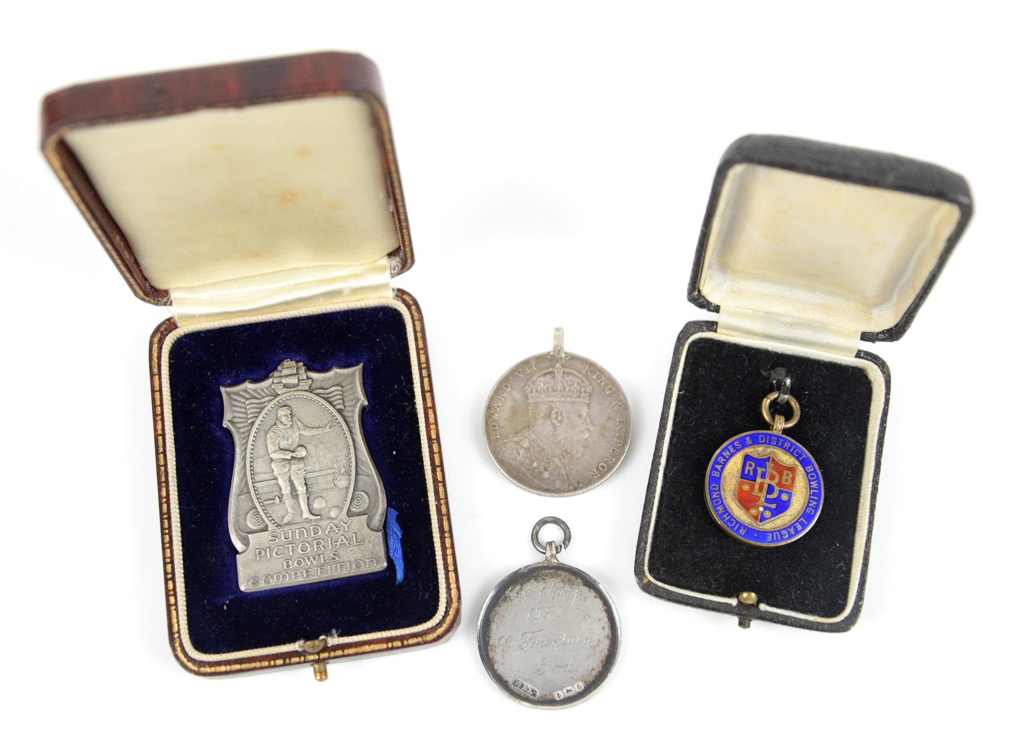 Fitted cased silver prize medal, a silver and enamelled fob cased, another silver large fob and a