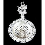 Dutch silver tea strainer with a handle in the form of a galleon ship and windmill decoration to