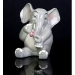 Lenci, Elephant, modelled seated holding a flower, painted marks, 8.5cm high Note: Catalogue No.