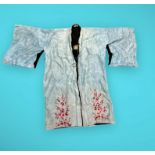 A collection of antique Oriental garments comprising a pale blue silk kimono with pink and red