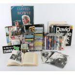 A Collection of David Bowie memorabilia including vinyl LP albums, badges, cassettes, VHS tapes,