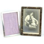 Two silver photo frames both rectangular form