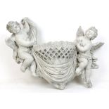 A cast concrete wall pocket in the form of two cherubs holding up a basket, 43cm wide