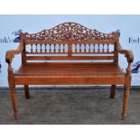 Indian teak settle, 20th century, pierced arching back above spindles, slatted seat, scrubbing arms,