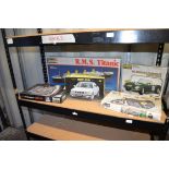 Four model kits including Titanic, car, motorbike and Chevrolet engine puzzle.