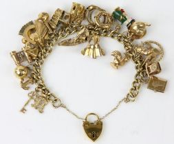 Gold charm bracelet, curb link bracelet with a heart padlock clasp and safety chain,