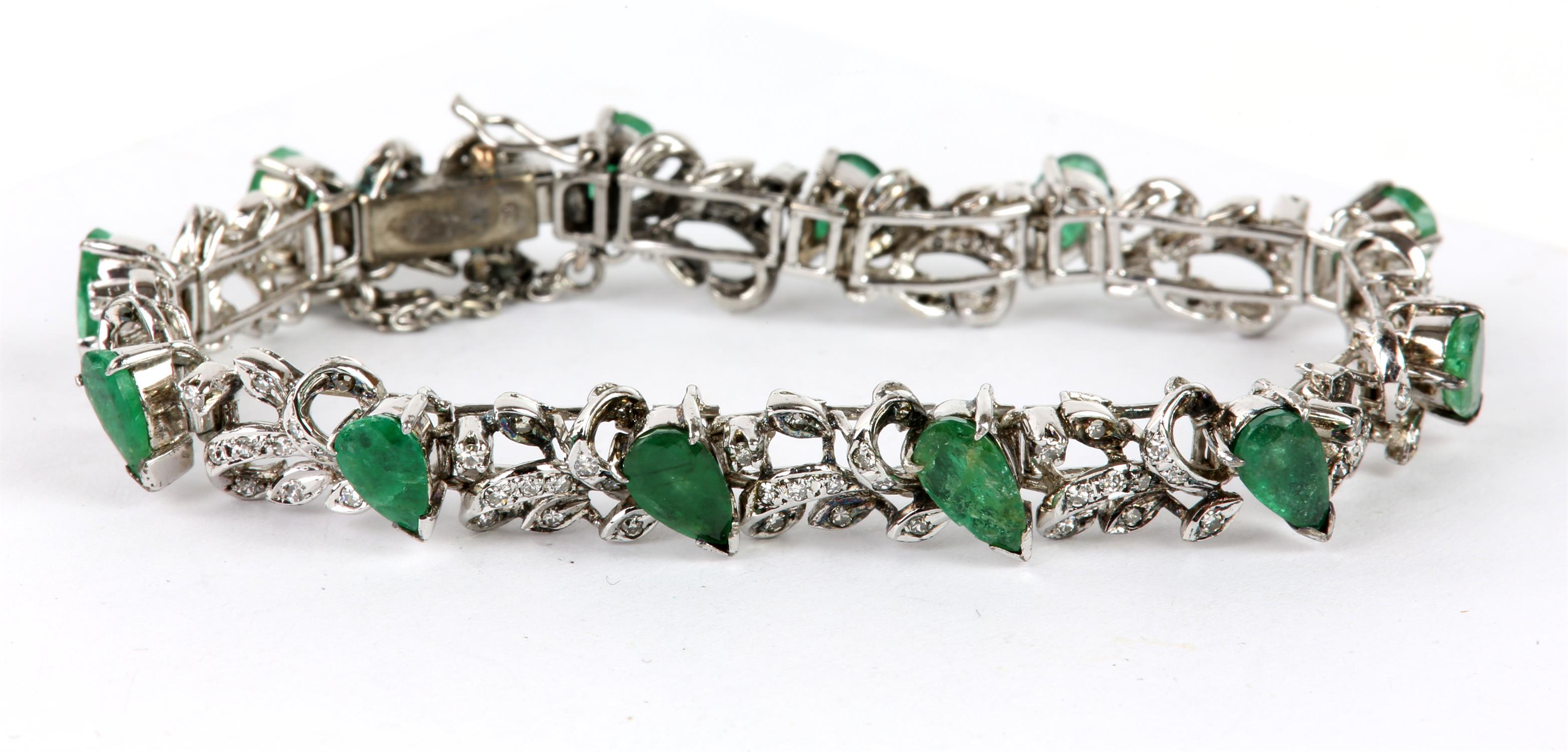 Emerald and diamond line bracelet, twelve pear shaped emeralds separated by a foliate design set