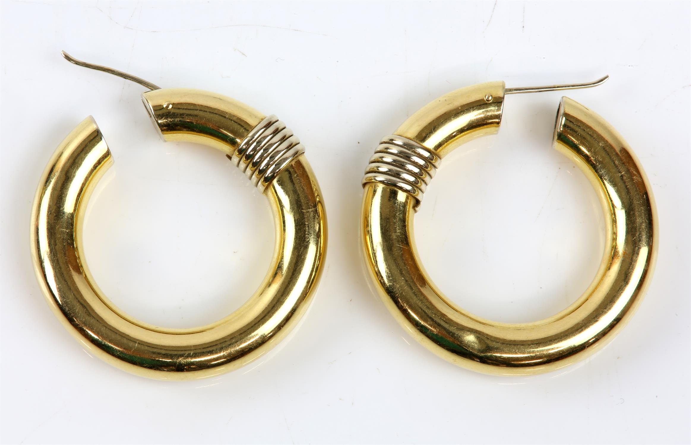 A pair of hoop earrings, with a gold spiral detail, in stamped 18ct