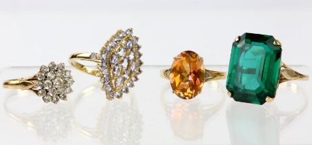 Four gold dress rings, including a ring set with an oval cut azotic topaz with a small diamond