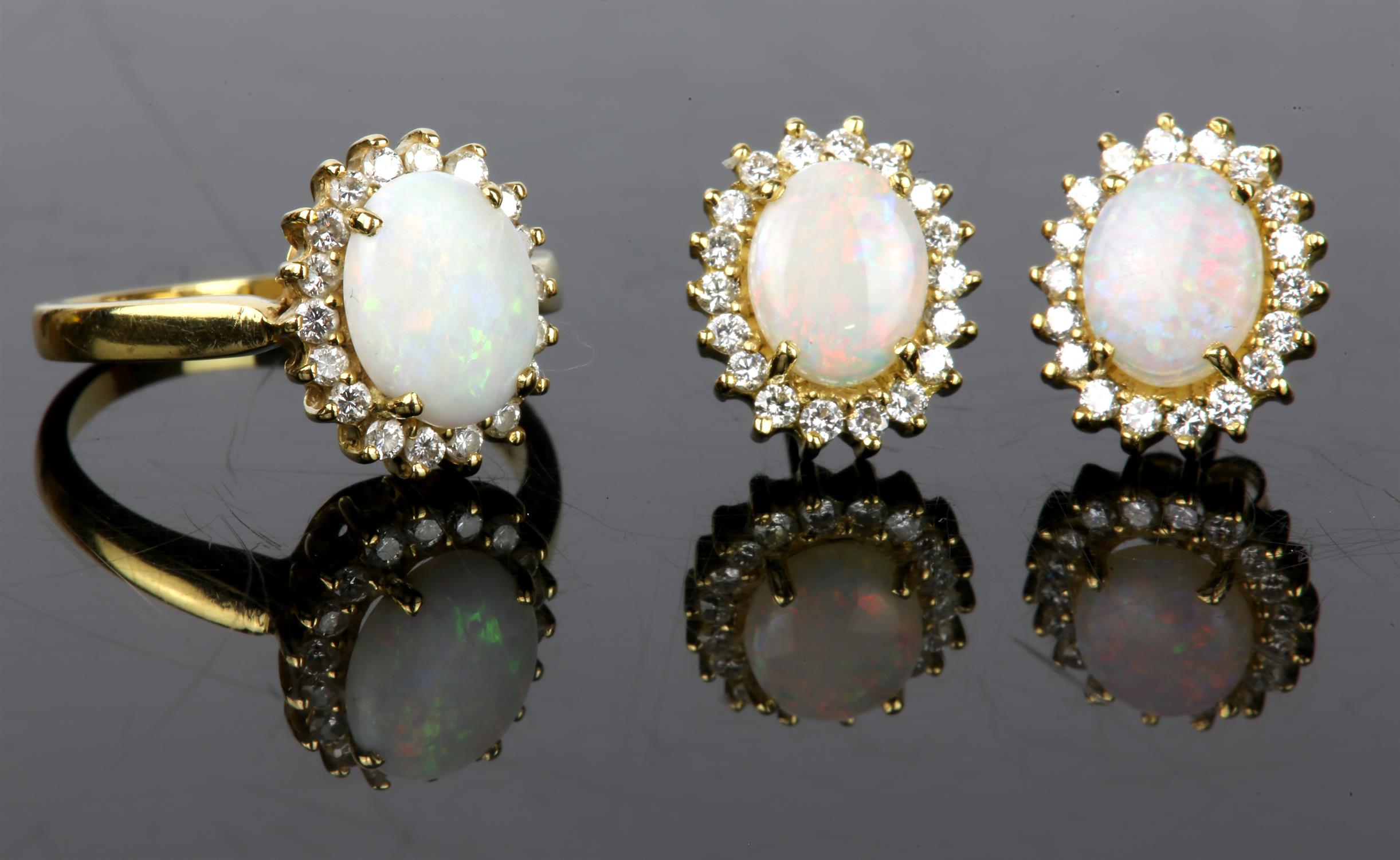 An opal and diamond ring, set with an oval cabochon cut opal weighing an estimated 1.