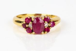 Ruby and diamond cluster ring, central oval cut ruby, with a round brilliant cut diamond and a