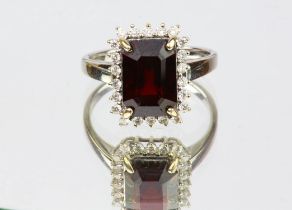 Red spinel and diamond cluster ring, an emerald cut red spinel weighing 4.24 carats,