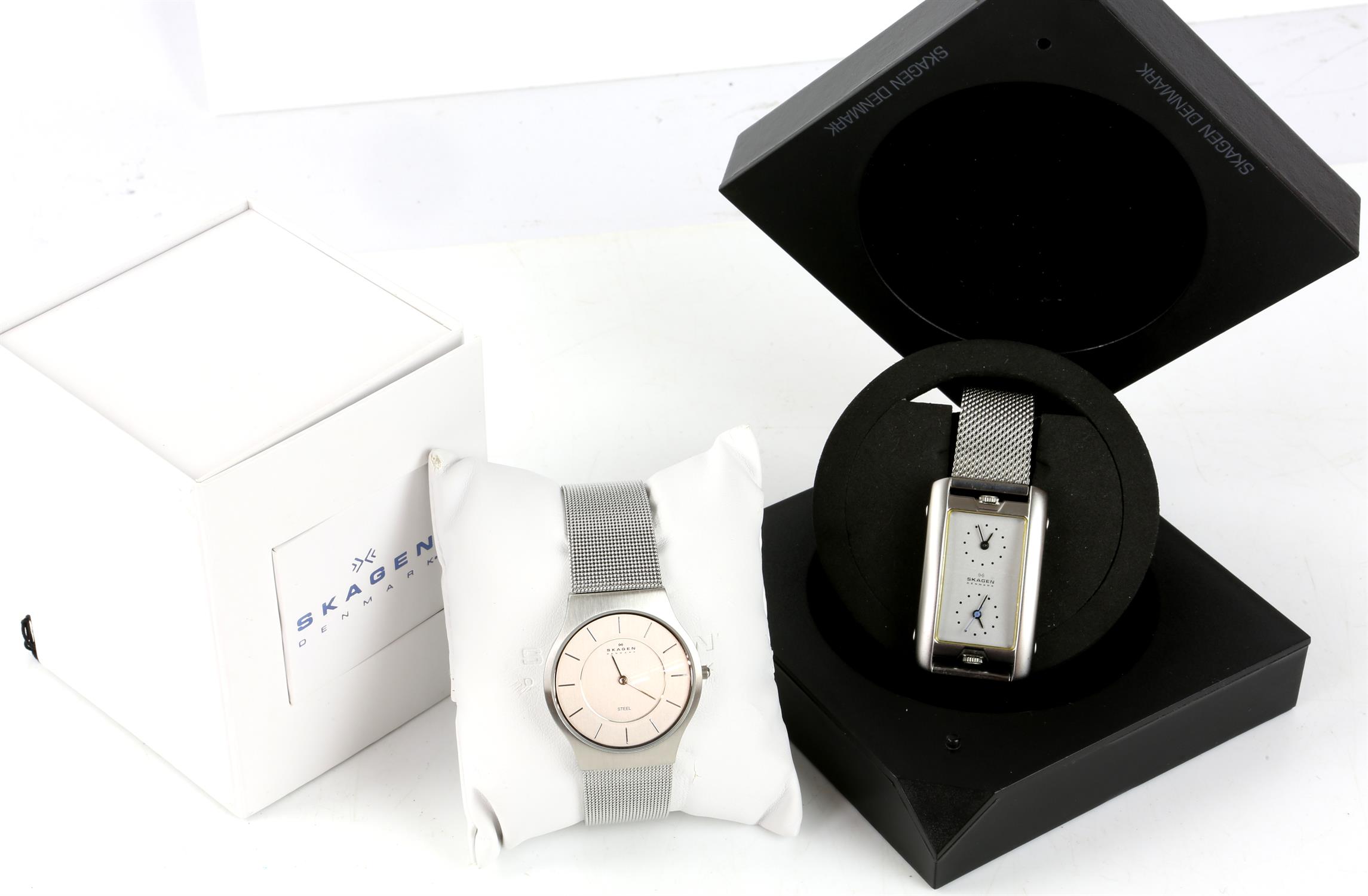 Two Skagen wristwatches with boxes, including a rectangular face dual time stainless steel men's