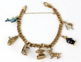 Gold charm bracelet, curb link bracelet with lobster clasp and safety chain, with seven charms,