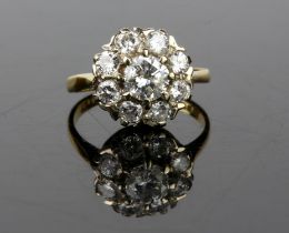 Diamond daisy cluster ring, with a central round brilliant cut weighing an estimated 0.58ct,