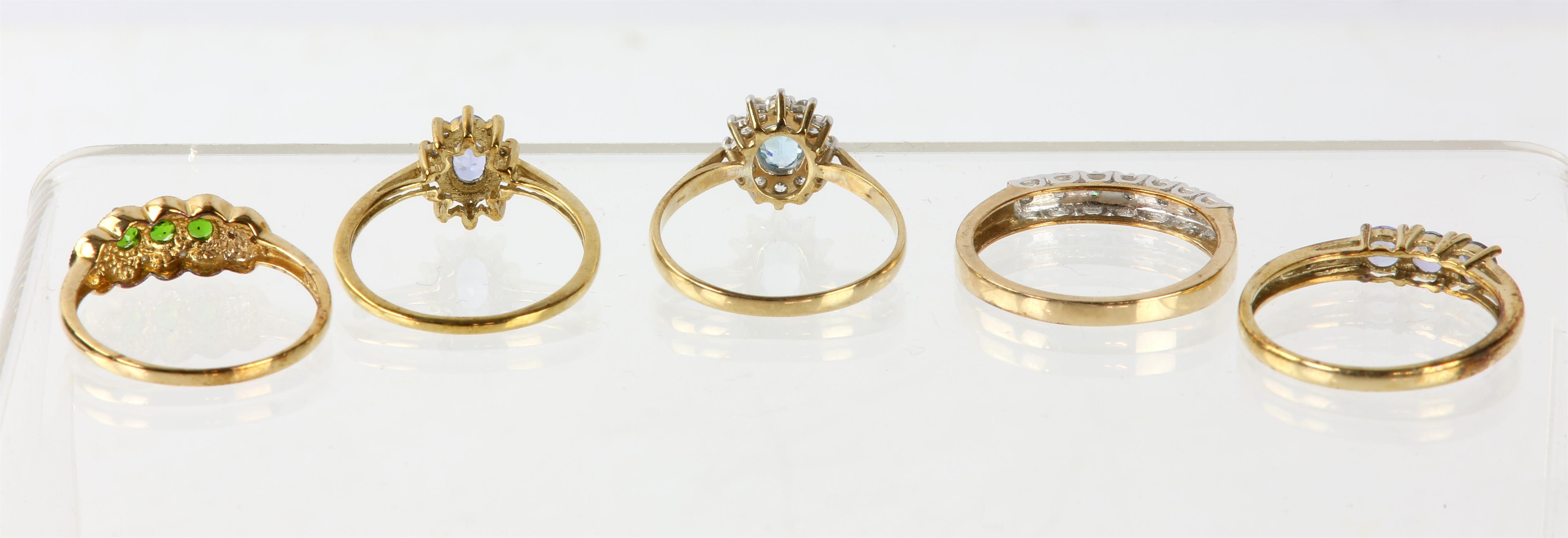 Five dress rings, including a blue topaz cluster ring set with an oval blue topaz and a surround of - Image 2 of 3