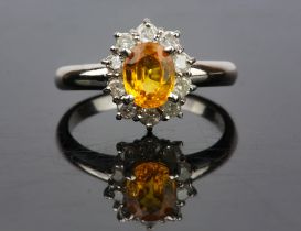 Yellow sapphire and diamond cluster ring, an oval cut yellow sapphire, estimated sapphire weight 0.