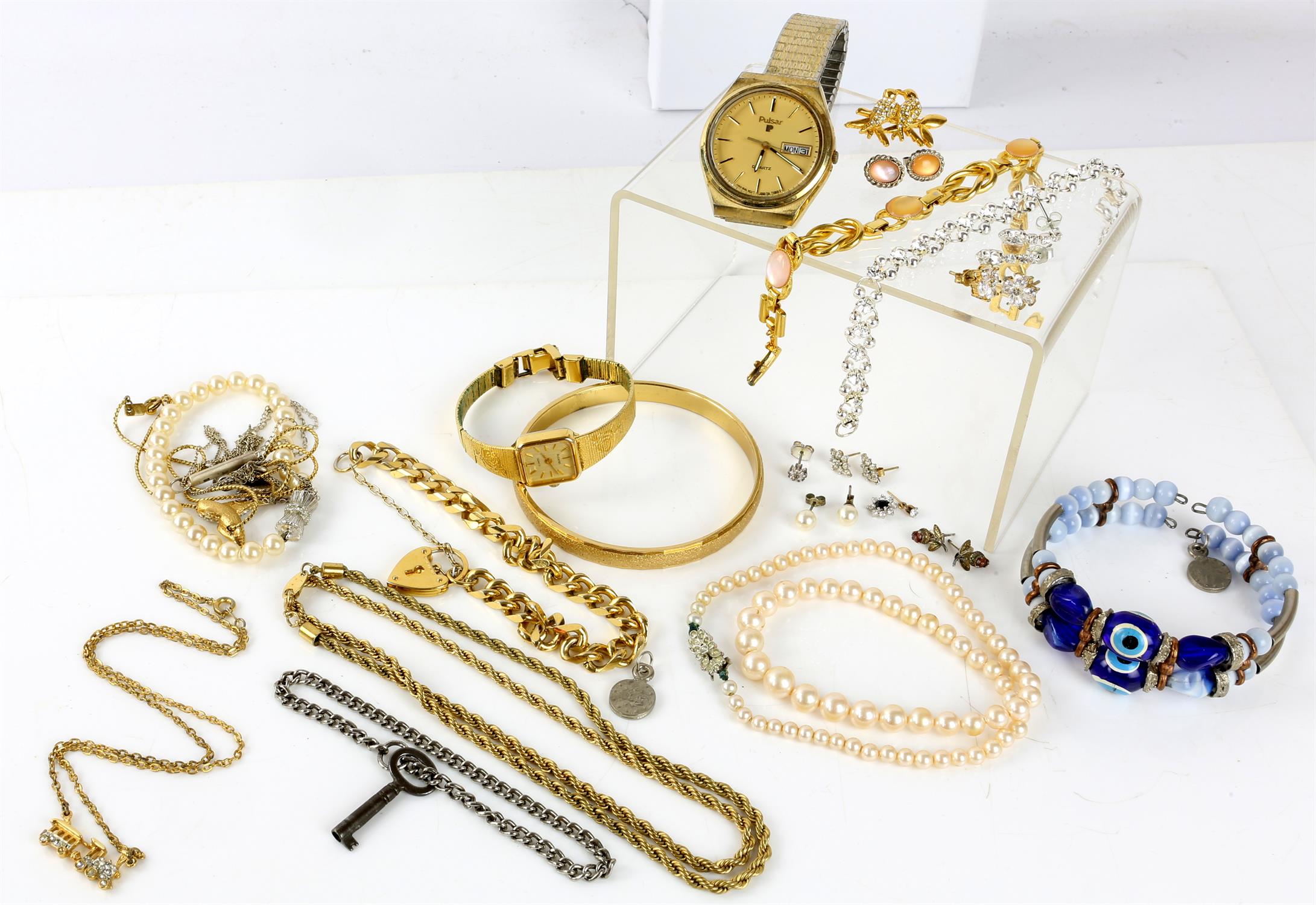 A collection of costume jewellery including faux pearl necklaces, an Accurist watch,