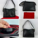 One black structured leather top-handle BALLY handbag with two front pockets and red suede lining.