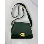 A quality dark green leather vintage DUNHILL structured handbag with long strap, cosmetic mirror