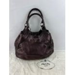 A large iridescent purple slouch double top-handle PRADA handbag with silver hardware, key fob,