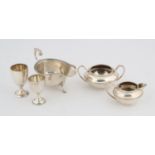 Five silver items, matching small sugar bowl and cream jug, two eggcups, and a sauceboat, 11.