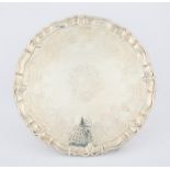 George III silver salver with shaped border and engraved armorial, on four scroll feet,