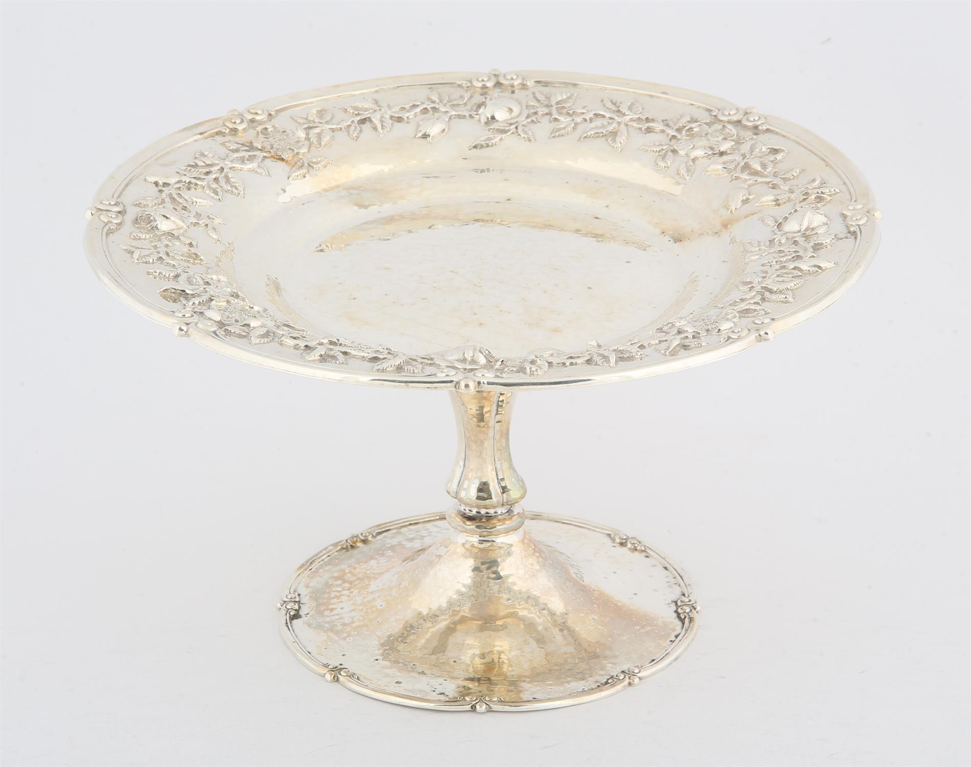 George V, silver tazza with hammered decoration and embossed floral decoration on round foot,