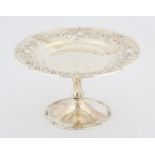 George V, silver tazza with hammered decoration and embossed floral decoration on round foot,