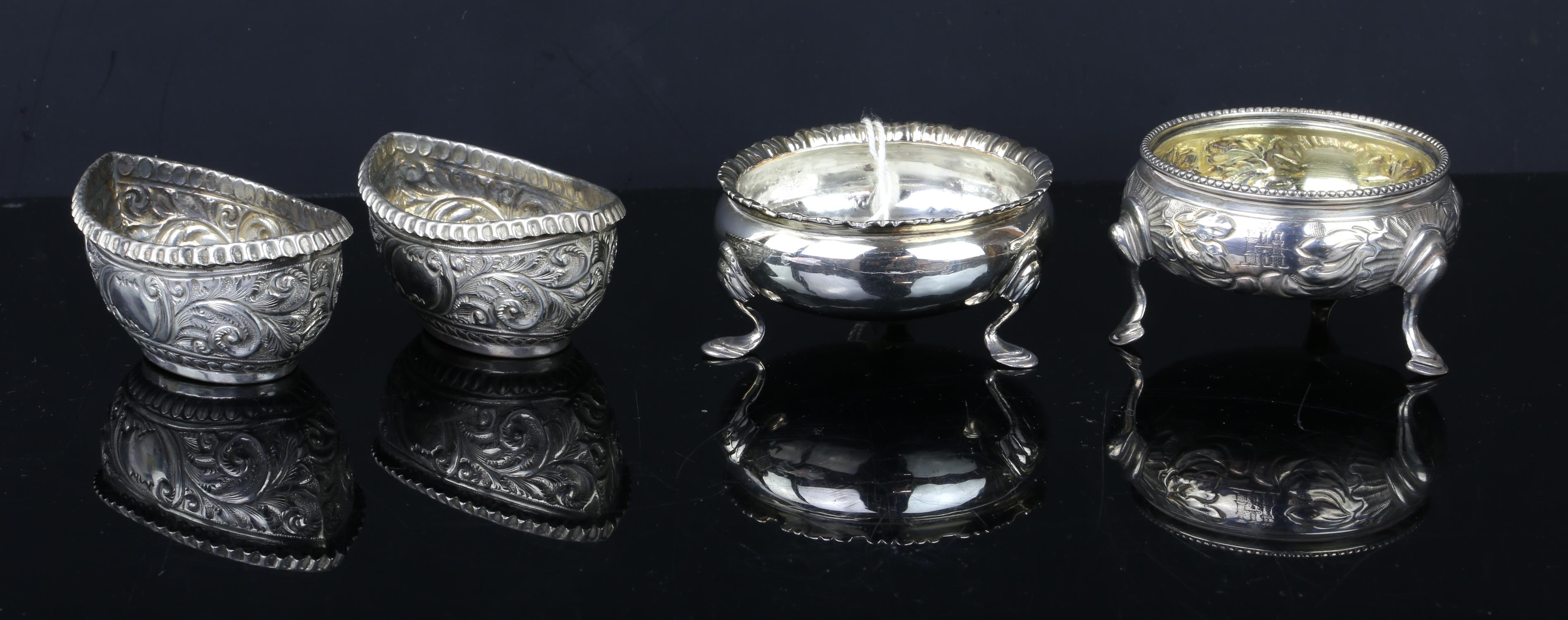 Pair of Edward VII boat shaped silvre salts with embossed decoration, by Mitchell Bosley & Co