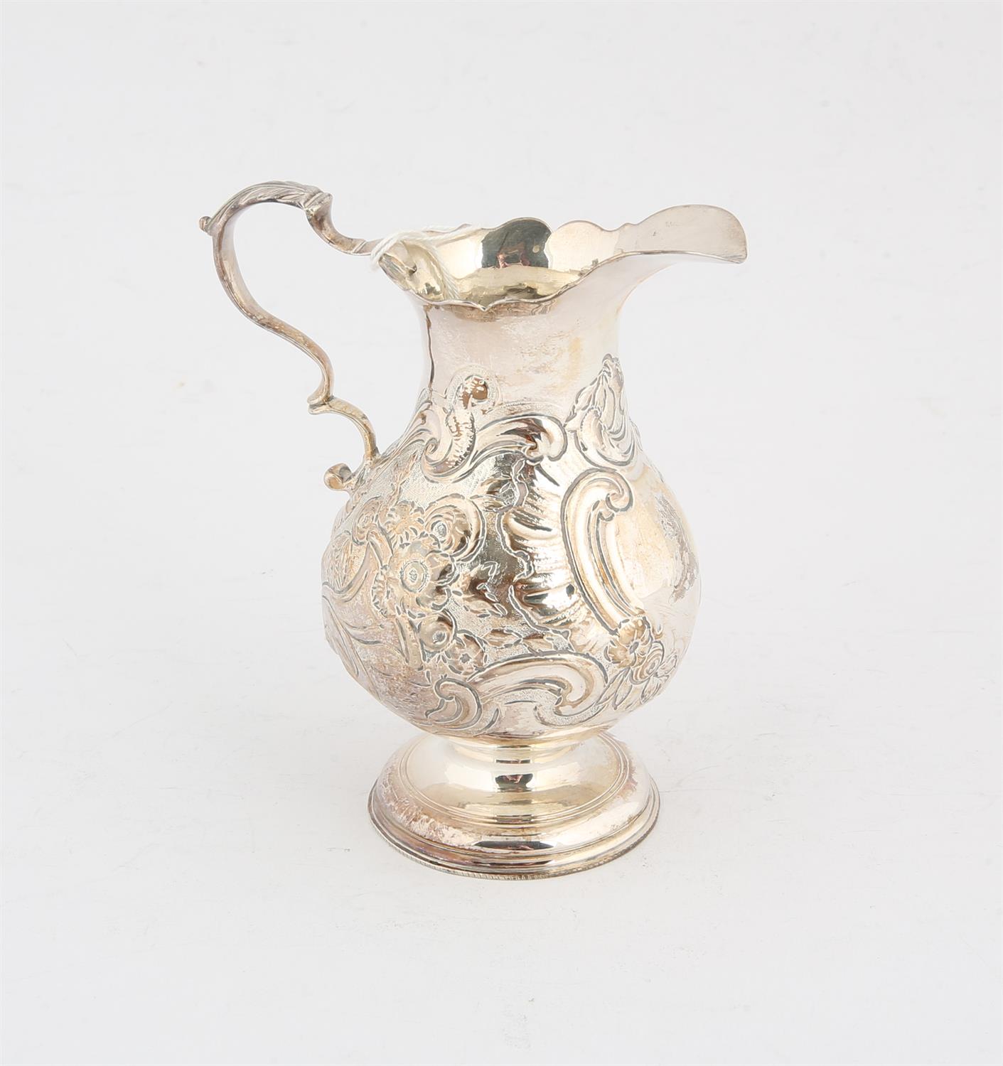 George II silver cream jug with embossed decoration, a cottage and flowers, London 1746, 3.