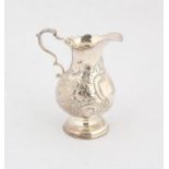 George II silver cream jug with embossed decoration, a cottage and flowers, London 1746, 3.