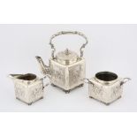 Continental silver three piece tea service, of square form, moulded with Teniers type scenes,