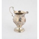 George II silver cream jug , with embossed flower and foliage decoration, on a round foot,