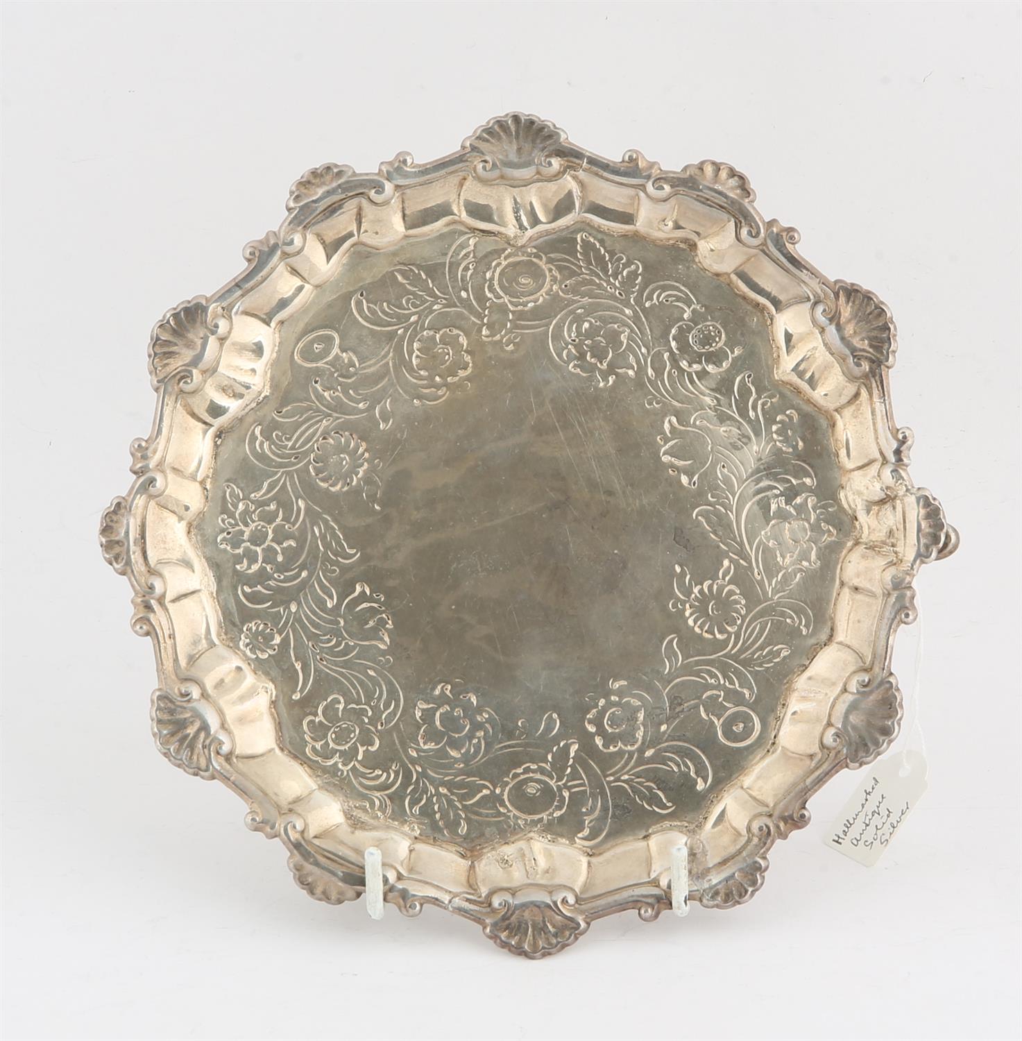 George II, silver waiter with shaped border on three feet, engraved decoration, by Ebenezer Coker,