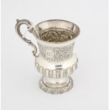 Victorian silver christening mug, with embossed decoration on a round foot, Sheffield 1850,