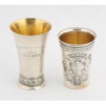 Continental silver beaker wirh coat of arms in relief and a second beaker, both late 19th and early