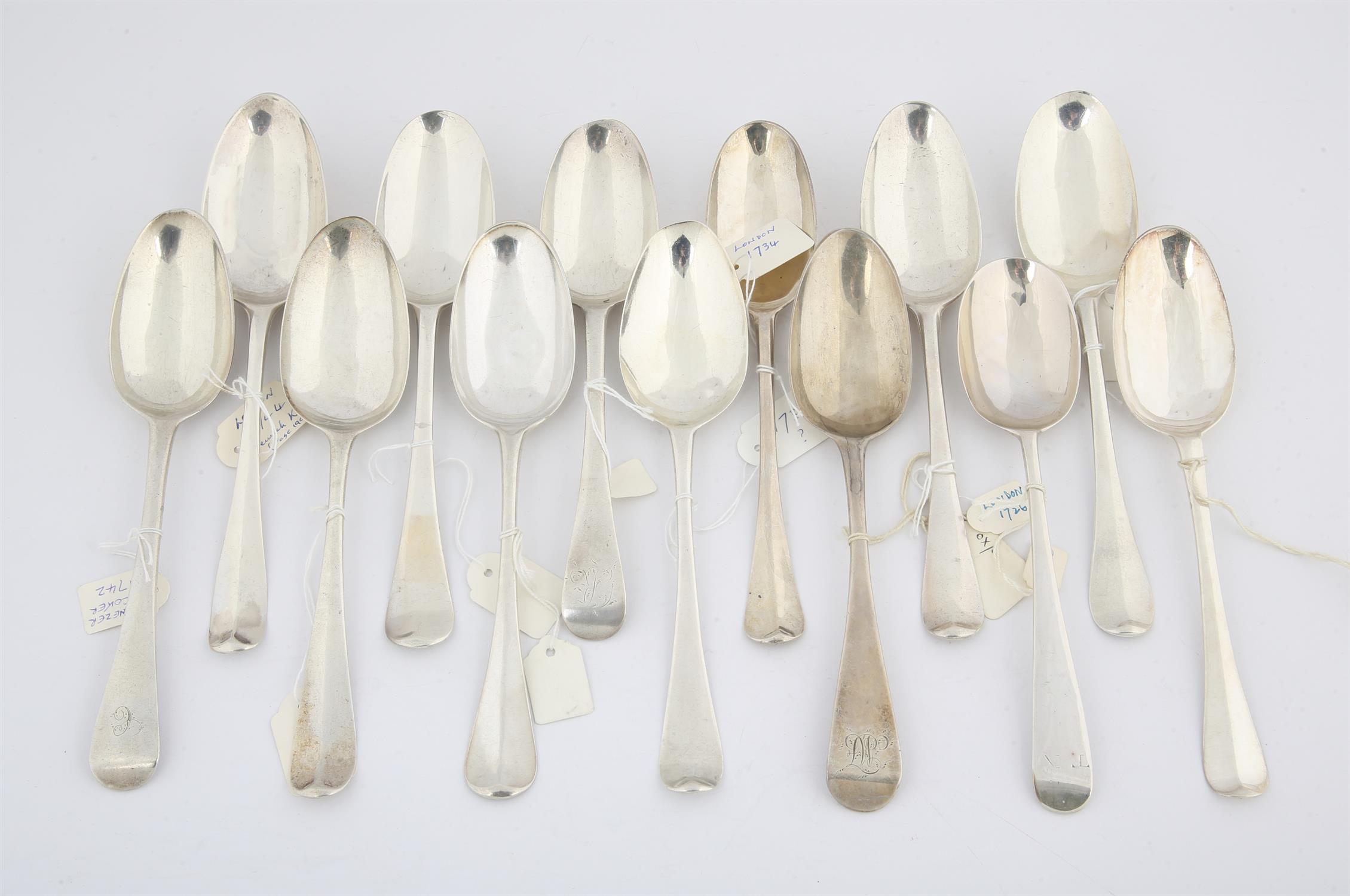 Thirteen various 18th century silver Old English Pattern table spoons, 23.6 ozs 734 grams