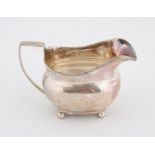 George III silver cream jug with a band of decoration on four ball feet, 4.8 ozs 148 grams SILVER