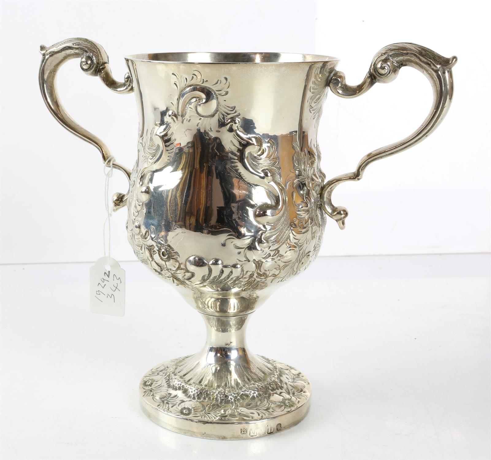 George IV silver two handled cup with shaped handles and embossed decoration, 67 cms high, 14.