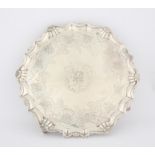 George I round silver salver with shaped shell and scroll border, on four scroll feet, London 1718,