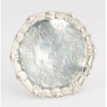 George II, silver waiter with shaped border on three feet, engraved decoration, by John Robinson,