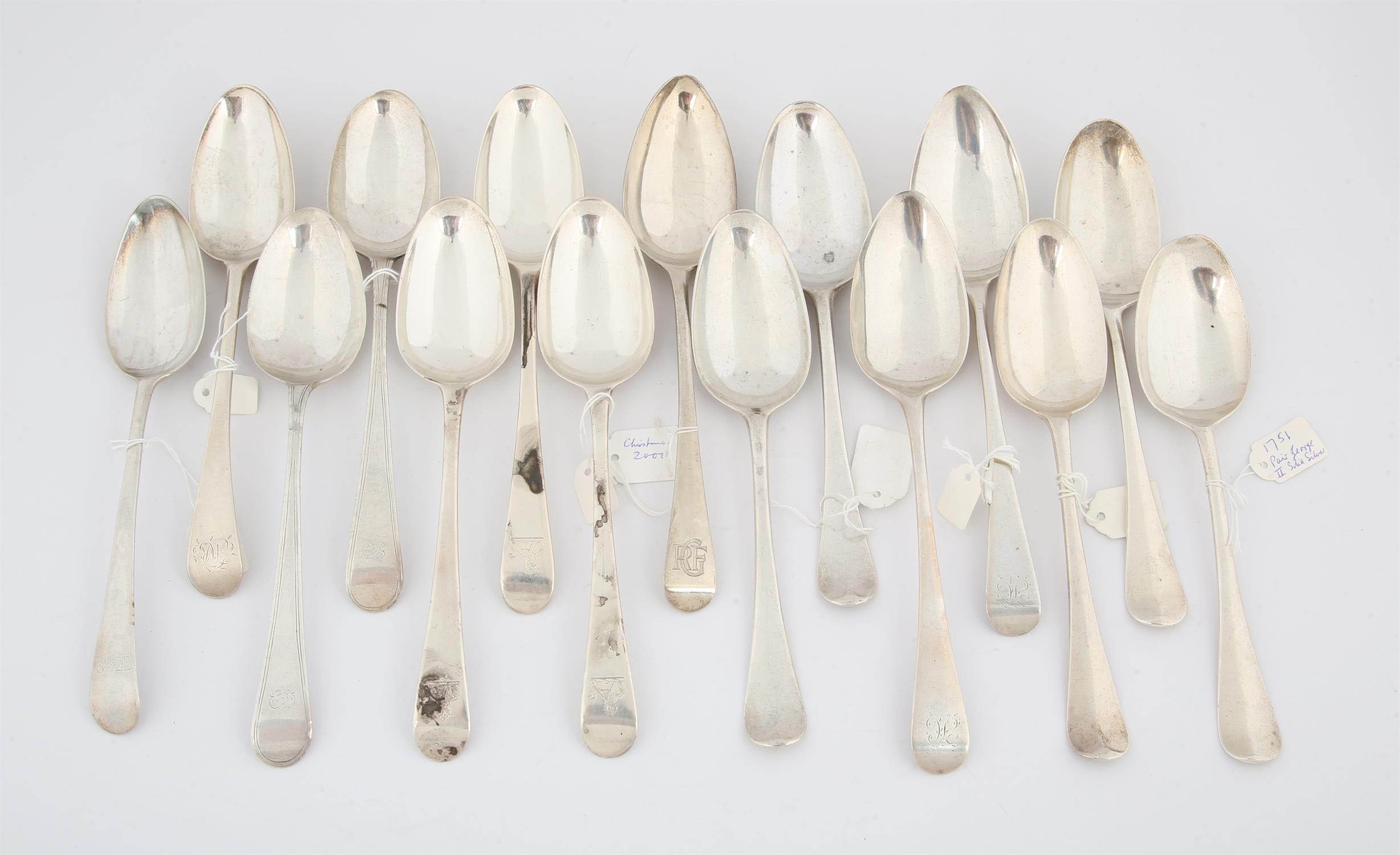 Fifteen eighteenth century silver Old English Pattern table spoons, some pairs and various dates,