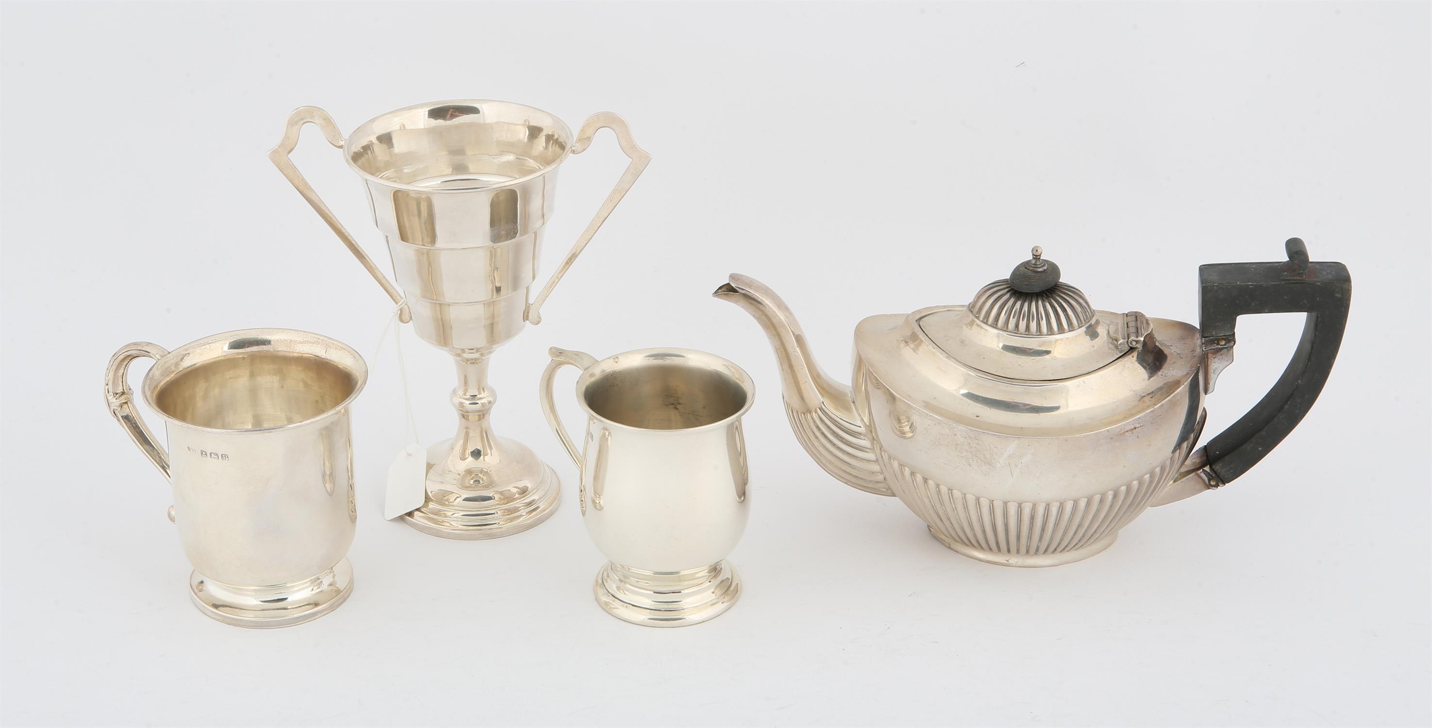 Silver items, comprising a small half reeded teapot with ebonised handle and knob.